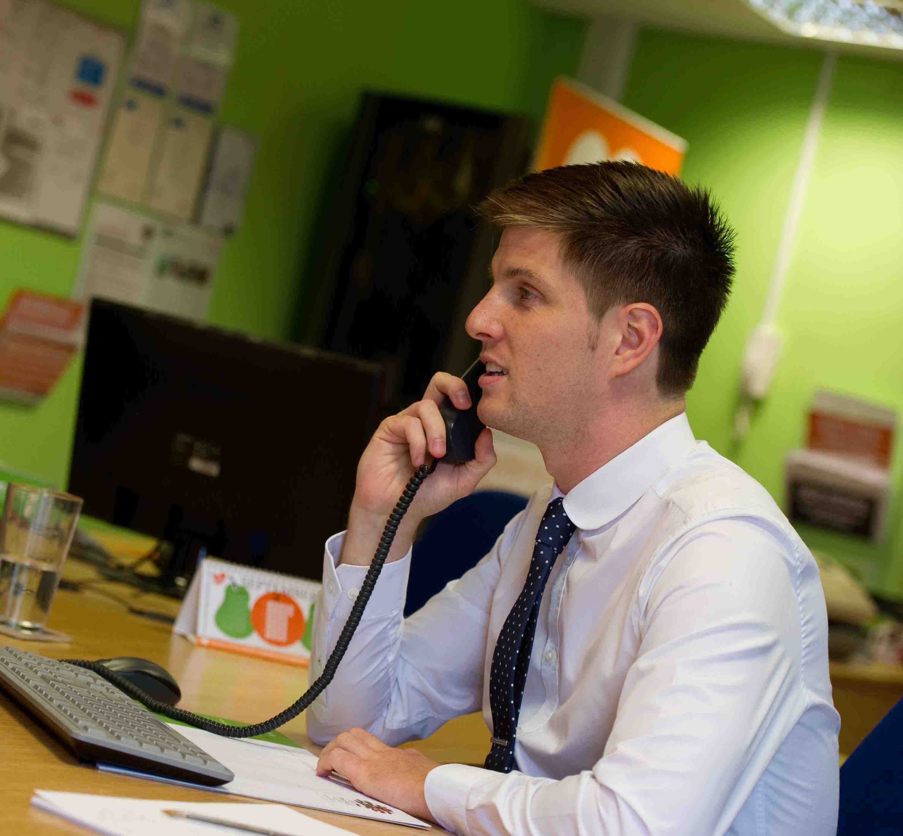 Jack O'Brien, (Director) on the phone wearing shirt and tie in the Prime Appointments office