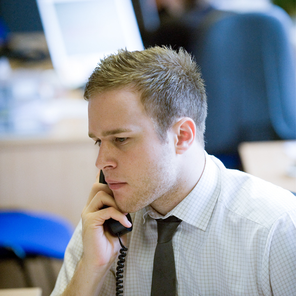 Olly Murs working on the phone whilst working for Prime Appointments in 2007, wearing grey tie and shirt