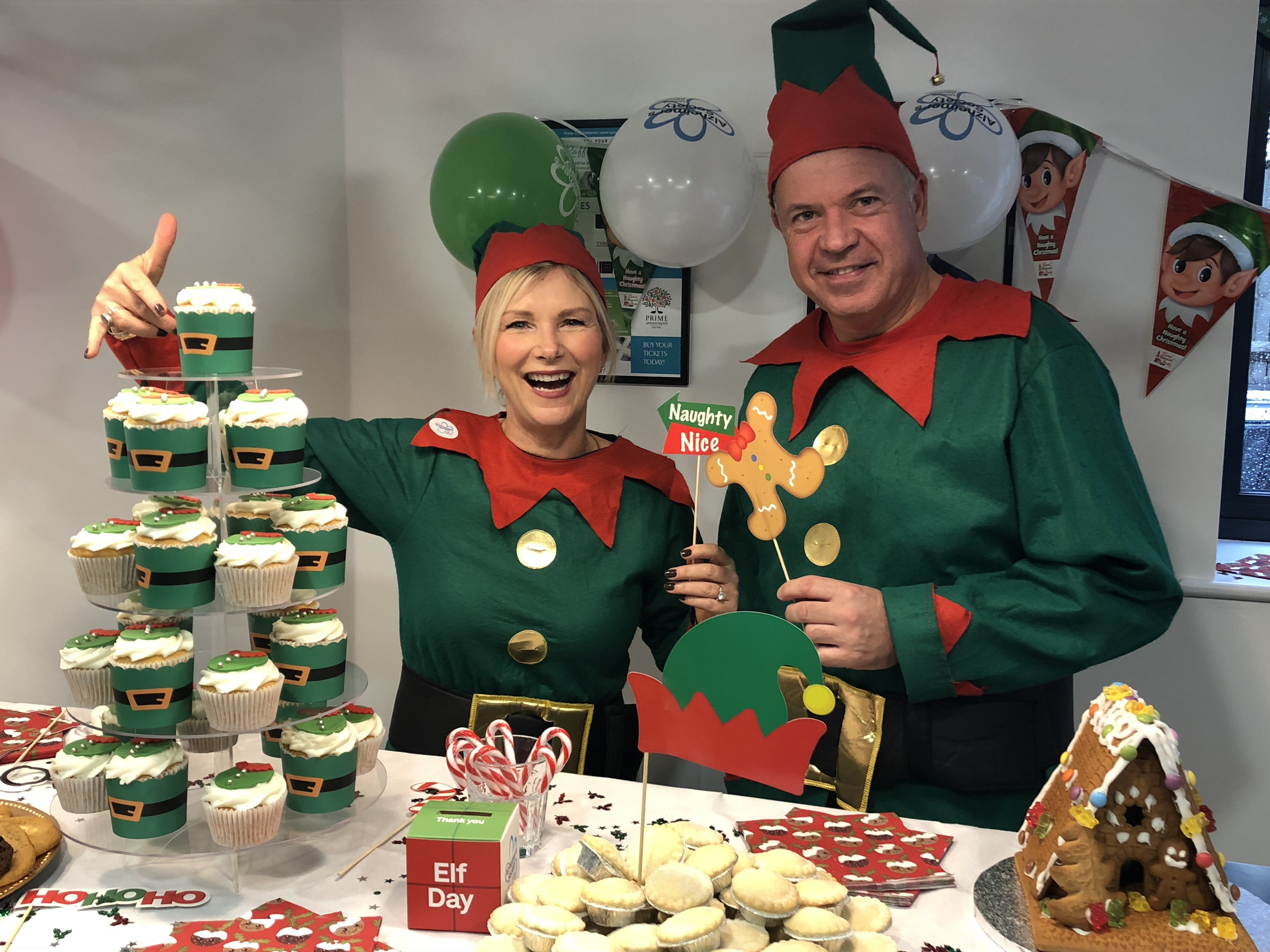 Robyn Holmes, MD & Peter Holmes, Director dressed in Elf outfits in aid of Alzheimers