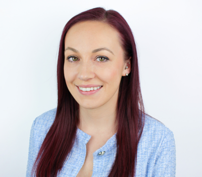 Georgie Lewis, Office & Accounts Administrator, wearing smart blue jacket with a white background, photo taken at Prime Appointments HQ in Witham