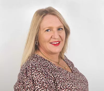 Louise Sutton (Accounts) wearing colourful blouse, photo taken at Prime Appointments HQ, white background in a photo 2